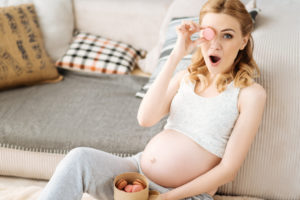 pregnant woman eating macaroons