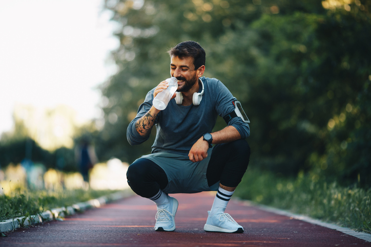 fit healthy man drinking water